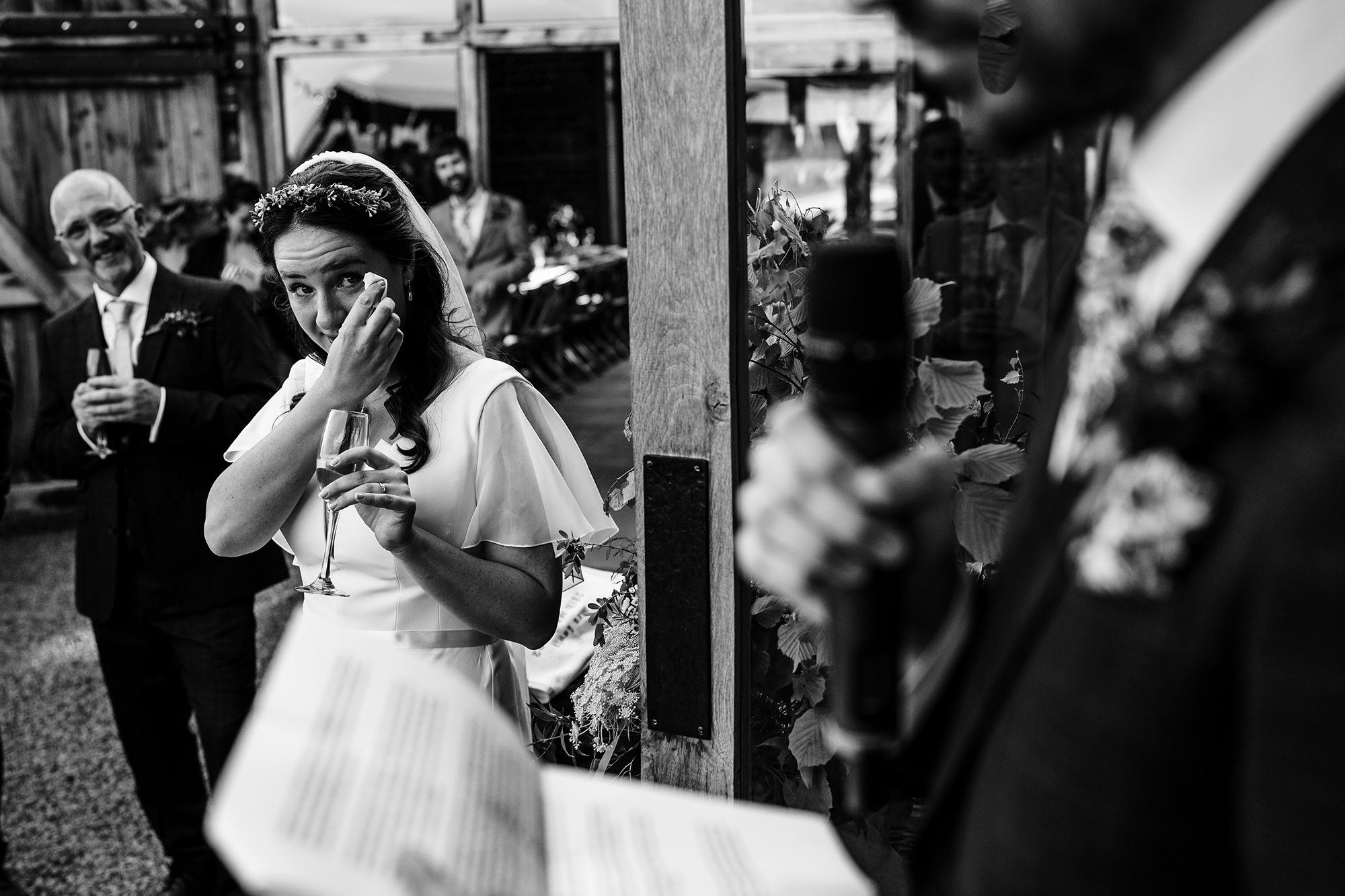 Bride wiping away a tear during an emotional wedding moment