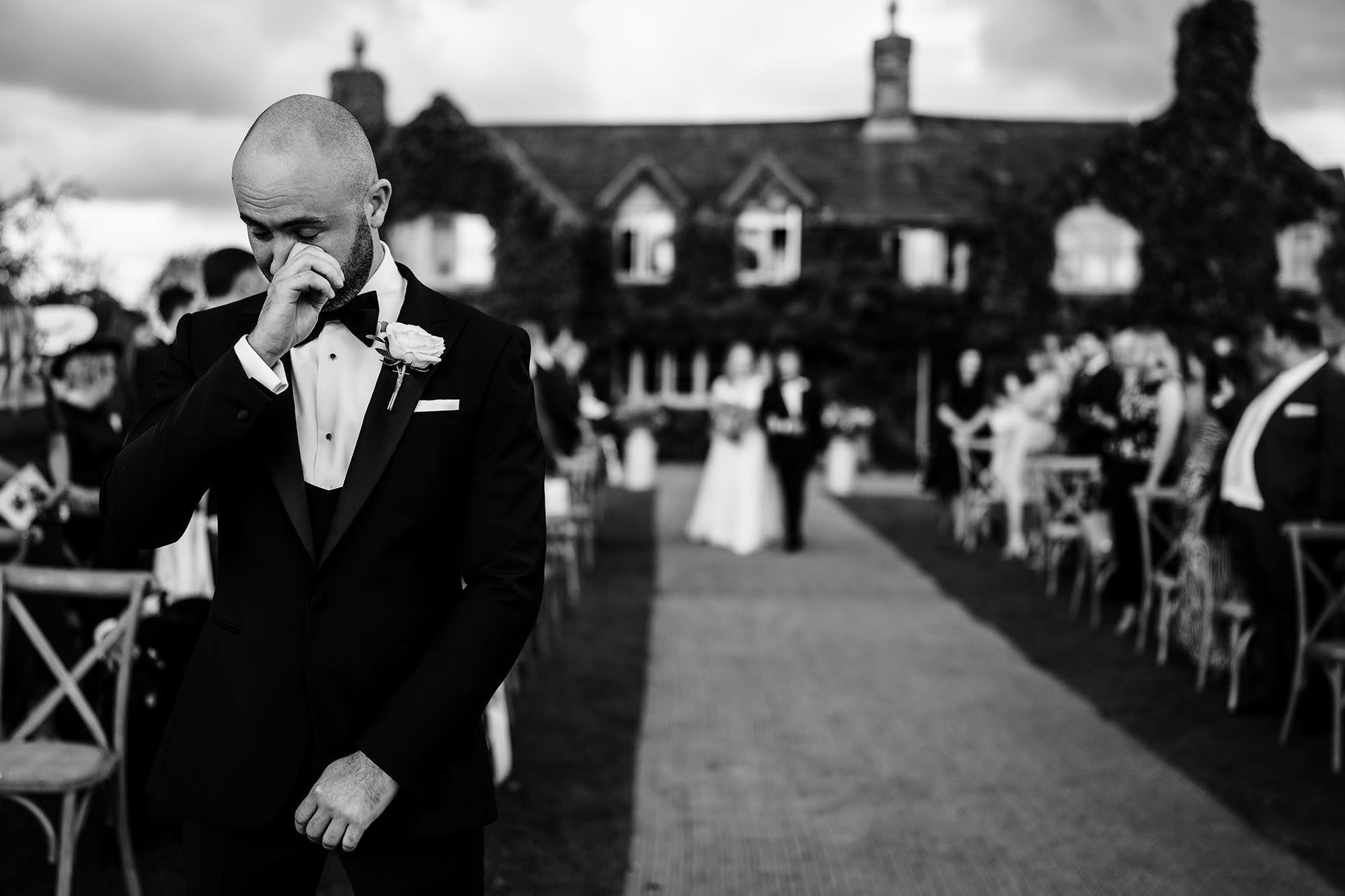 Groom waiting for his bride in an emotional candid wedding moment