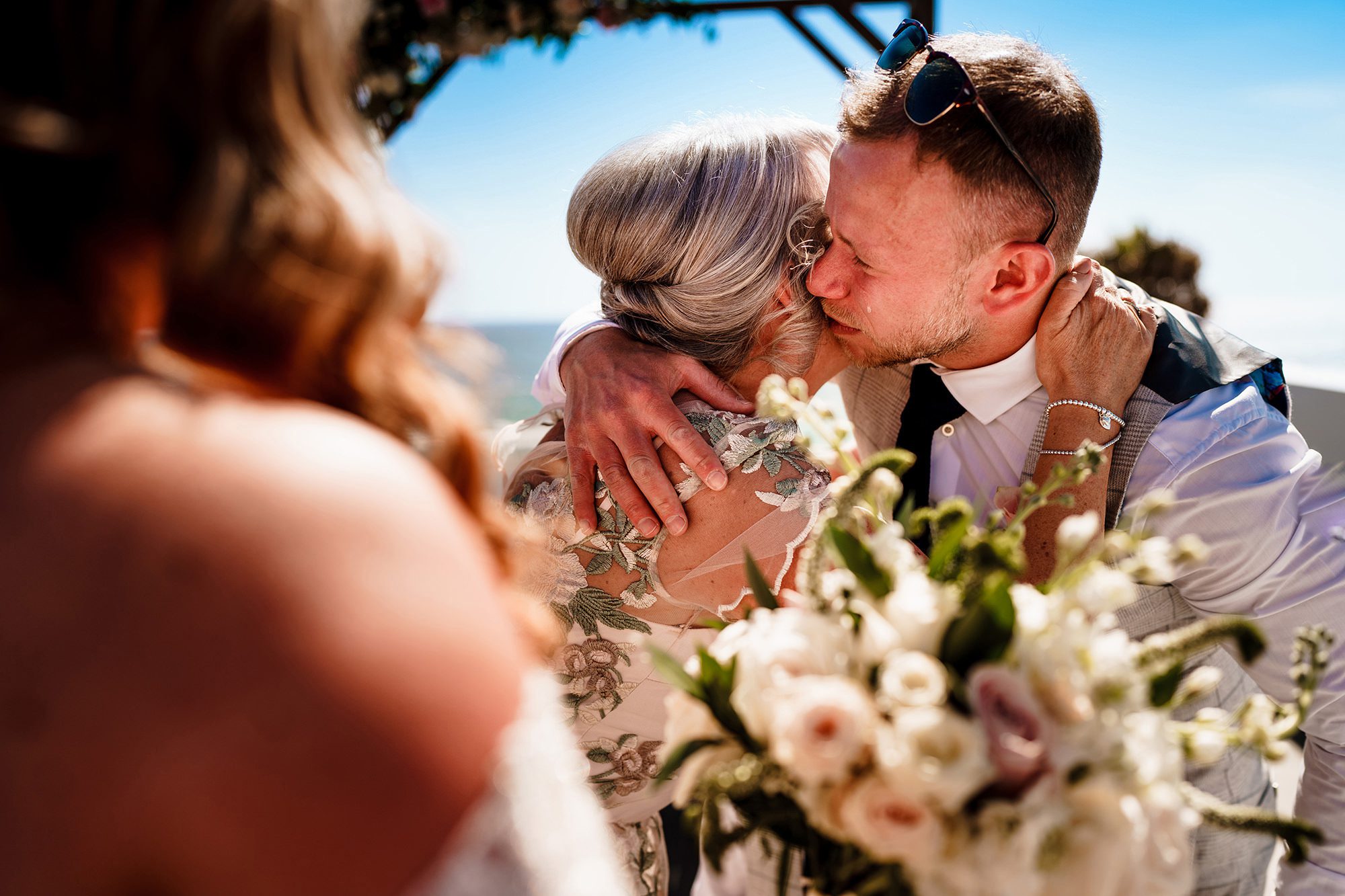 Groom crying during the wedding ceremony in a candid photograph
