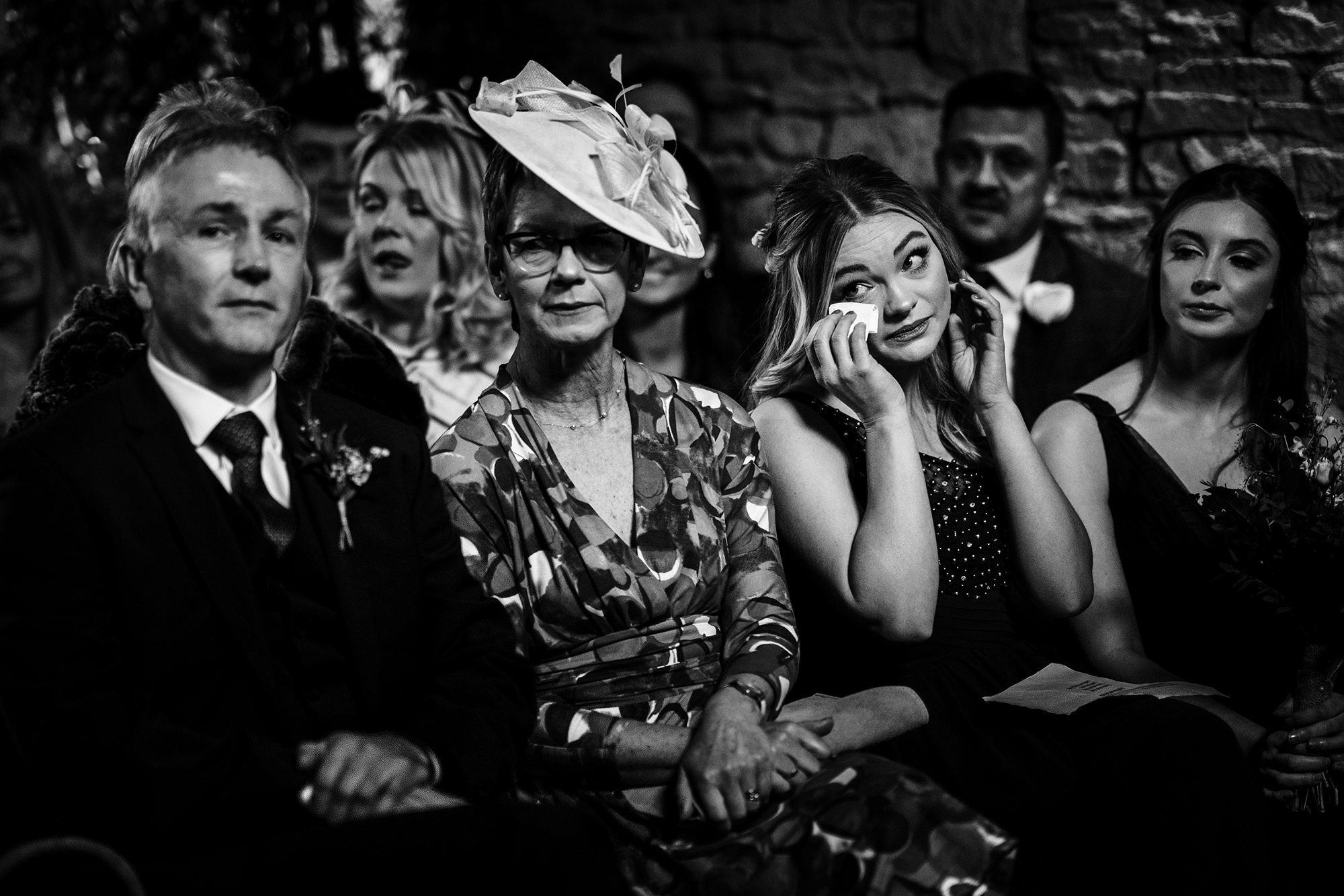 Bridesmaid wiping away tears during a Cripps Barn wedding in the Cotswolds
