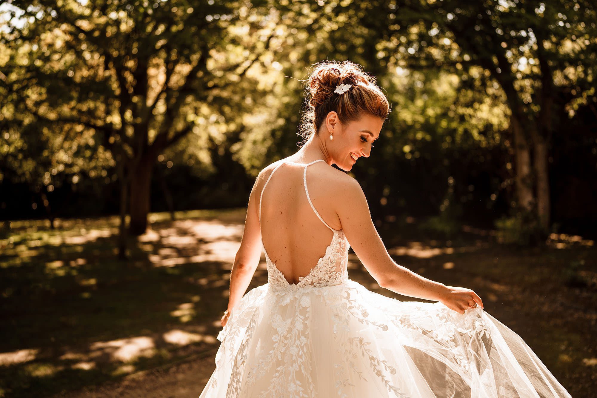 Bride with her wedding dress in the Cotswolds countryside