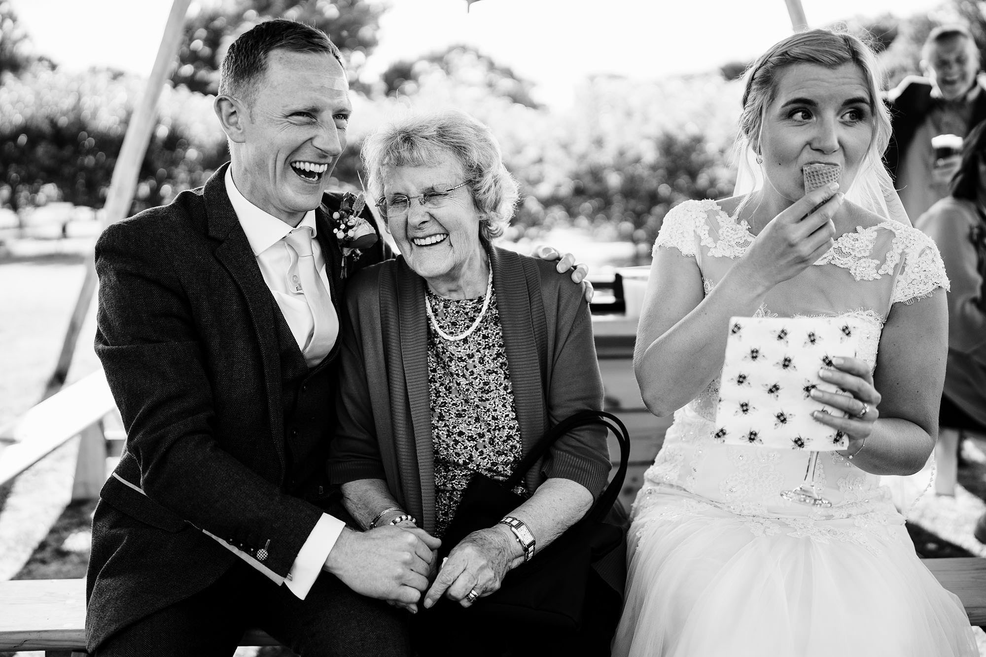 Outdoor Cotswolds wedding with the bride eating ice cream in the sunshine