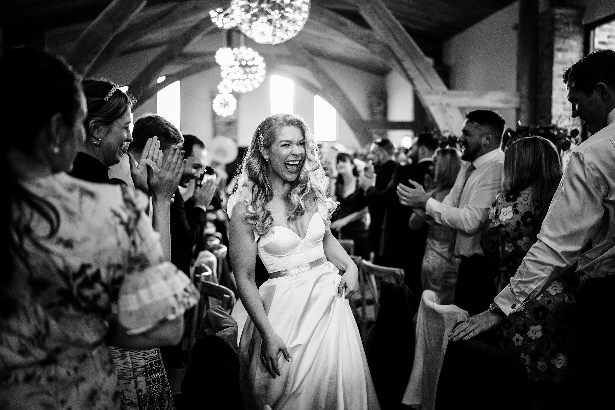 Bride walking through guests at a Cotswolds wedding venue