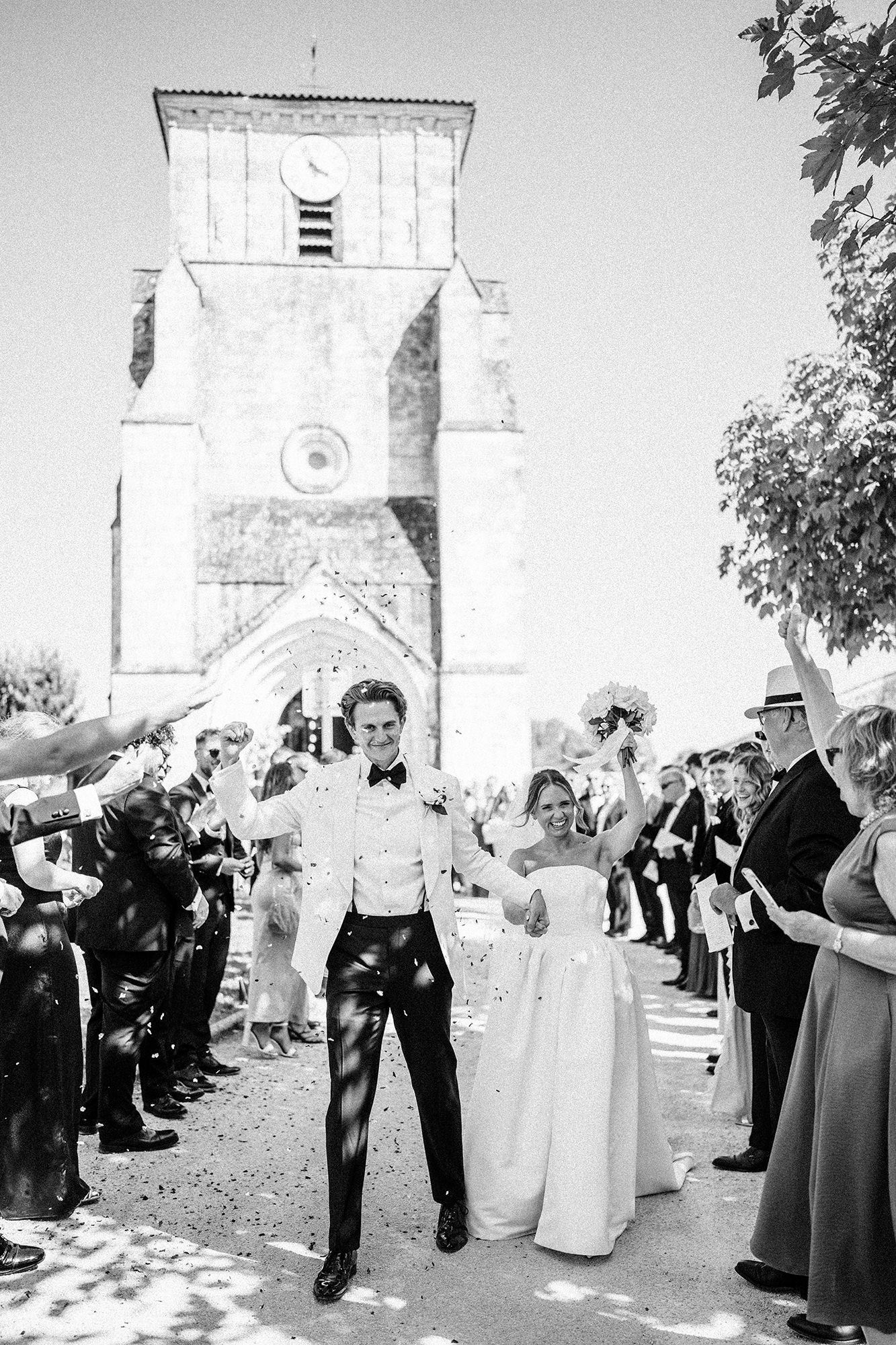 Confetti moment outside a church captured in a stylish documentary wedding photography style